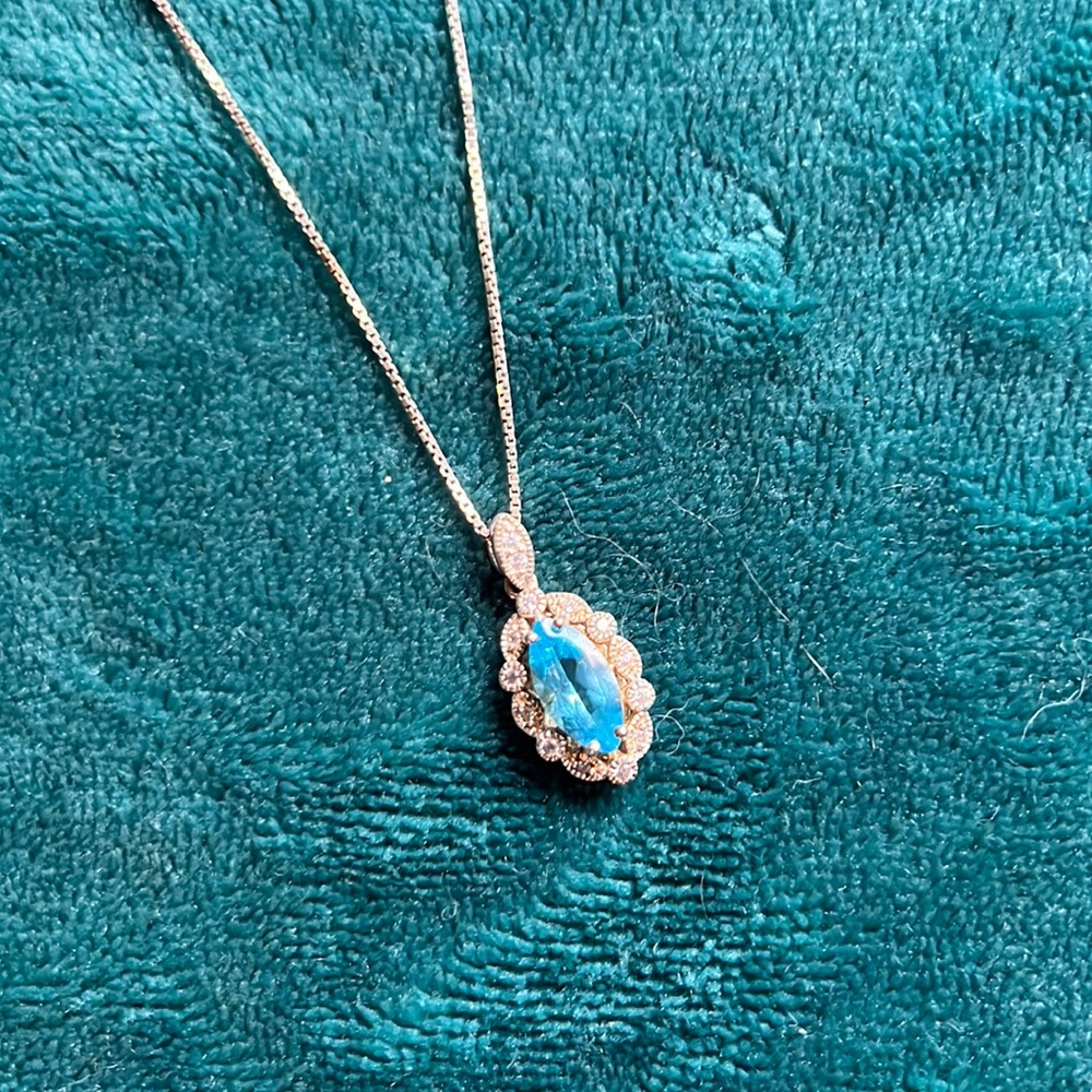 Silver chain with aquamarine stone surrounded by cz